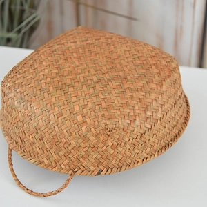 Detailed close-up showing the dense weave texture of the natural seagrass storage basket