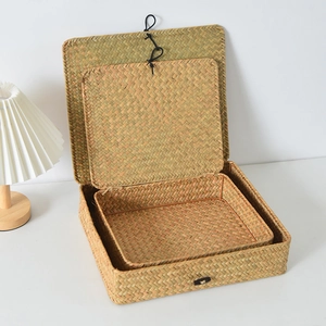 Detail of two-piece hand-woven straw storage boxes with elastic buckle closures