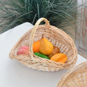 Handcrafted wicker picnic basket with handle, filled with decorative fruit and vegetables