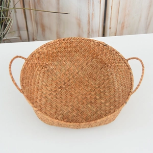 Detail of handwoven seagrass storage basket with reinforced handles and natural fiber texture