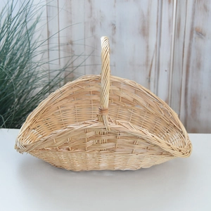 Close-up of handmade woven willow picnic basket with natural wood texture and sturdy handle