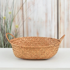 Close-up of natural seagrass storage basket featuring tight weave and durable handles