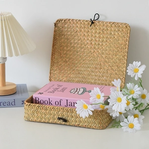 Detailed view of handmade woven seagrass storage box with lid and black cord buckle closure