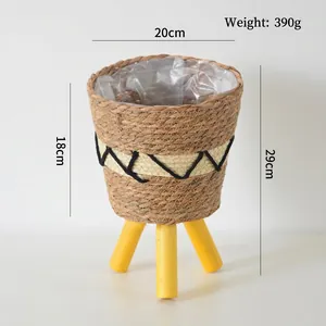 Detail view of woven flower basket with waterproof liner and yellow tripod wooden legs