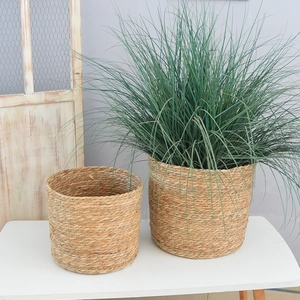 Detail of round straw woven basket showing natural plant fiber texture for home plants