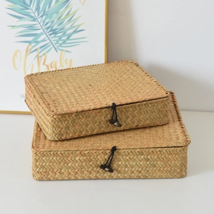 Detail of woven straw storage boxes with elastic loops and wooden button closures
