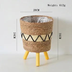 Detail of woven seagrass plant basket with yellow wooden legs and waterproof liner