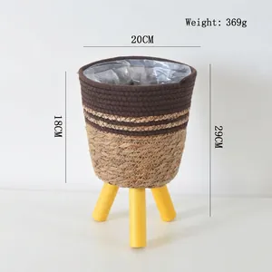 Detail view of woven plant stand with wooden legs and 20cm diameter dimensions