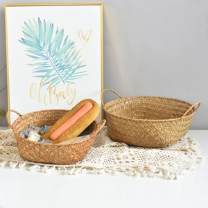 Close-up of natural seagrass woven storage baskets with dual handles and rustic texture