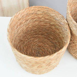 Detailed top view of the natural woven grass texture and spiral craftsmanship of a round basket