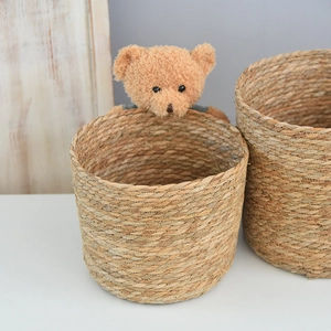 Close-up of natural woven straw flower basket showing tight spiral texture and quality