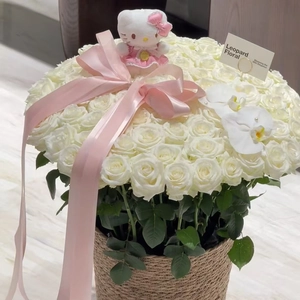 Detail of white rose flower basket featuring a cute plush toy and pink satin ribbon bow