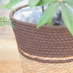 Close-up of handwoven plant basket featuring brown fabric and natural straw with waterproof liner