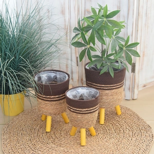 Detail of three-tier woven seagrass planters with wooden legs and waterproof lining