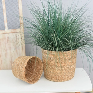 Detail of two handmade round woven straw flower baskets with natural plant fibers and textures