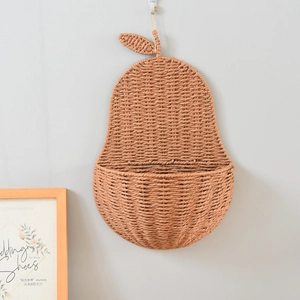 Detail of pear-shaped hanging wall basket made of hand-woven natural brown fibers