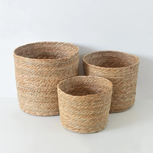 Three-piece nesting set of natural seagrass woven baskets for plants and home storage