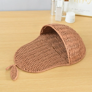 Detail of pear-shaped handmade woven wall basket with intricate paper rope texture