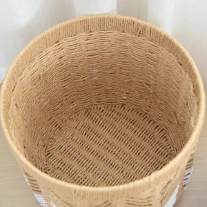 Macro detail of hand-woven round basket with natural texture and white base accent