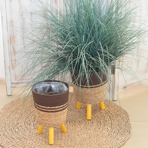 Detail of woven seagrass planter with waterproof PE lining and sturdy wooden tripod legs