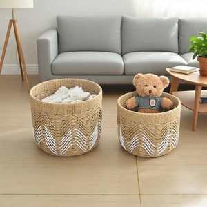 Detail of woven cotton rope storage baskets with toys and textiles in a living room