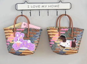 Detail of woven tote bags featuring 3D animal embroidery and geometric patterns