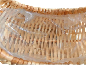 Close-up of hand-woven wicker basket with waterproof clear plastic liner interior detail
