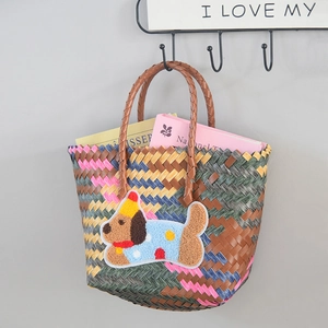 Close-up of colorful woven tote bag featuring a cute 3D cartoon puppy patch detail