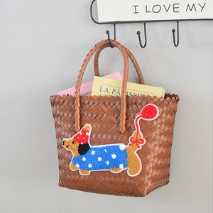 Detail of woven tote bag featuring a cute dachshund embroidery with heart balloon