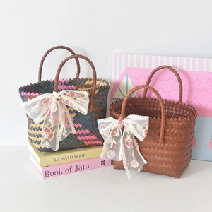 Detail of hand-woven tote bags featuring lace ribbon and delicate floral embroidery