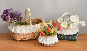 Three-piece set of woven wicker baskets with white lace trim and pearl handle detail