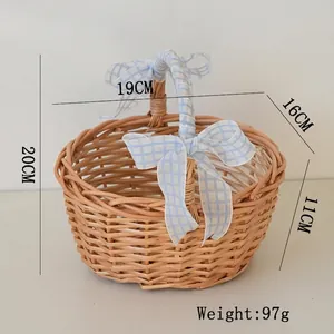 Close-up of handmade wicker picnic basket with blue gingham ribbon and bow decorations