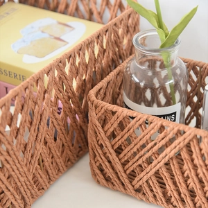 Close-up of woven storage basket with durable metal frame and rustic brown paper rope texture