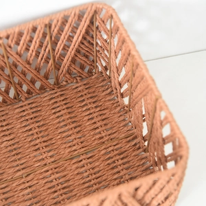 Close-up of hand-woven storage basket showing orange-brown diamond hollow weave pattern