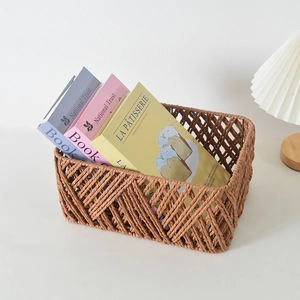 Detail of rectangular woven storage basket in khaki with hollow crisscross pattern