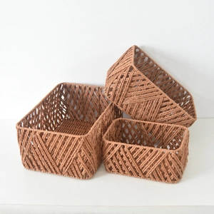 Three sizes of brown woven storage baskets with metal frames for desktop organization