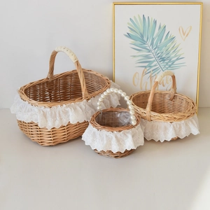 Close-up of handmade wicker picnic baskets with delicate white lace and pearl handles