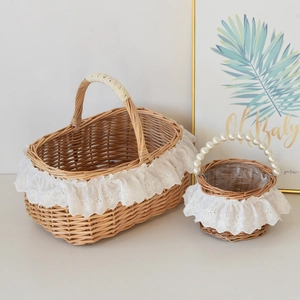 Detailed view of woven picnic baskets with lace trim and elegant pearl bead handle