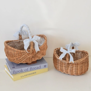 Detail of handmade wicker picnic basket featuring a blue checkered bow and liner