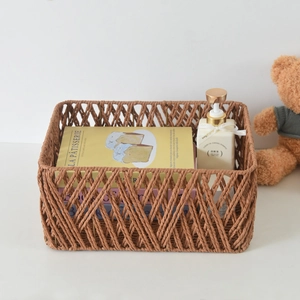 Detailed close-up of brown woven storage basket showing diamond cutout pattern