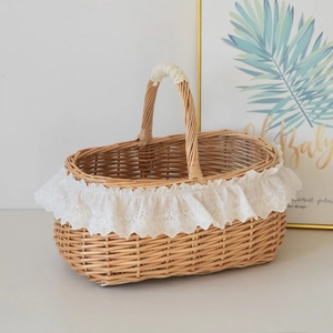 Close-up of woven wicker picnic basket with elegant white lace trim and sturdy handle