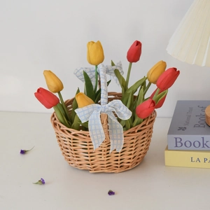 Handwoven willow picnic basket with blue ribbon bow and colorful faux tulips decor