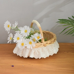 Detail of woven wicker basket with white lace embroidery trim and a decorative handle