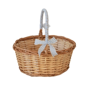 Handwoven wicker picnic basket with blue checkered ribbon handle and natural wood finish