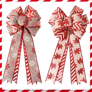 Detail of large double-layer Christmas bows featuring white snowflakes and red maple leaf patterns