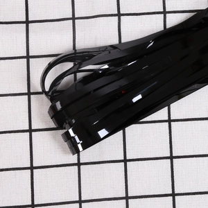 Detail of high-gloss black PET foil fringe curtain with shiny finish for party decor