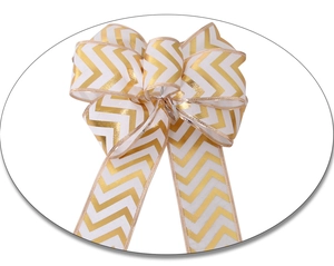 Detail of white Christmas bow with golden chevron patterns for holiday tree decoration