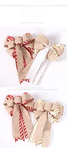 Detail of Christmas burlap bow with festive red white wavy trim for holiday tree decor