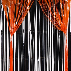 Halloween fringe curtain in black and orange foil for festive party backdrop decoration