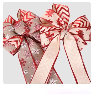 Detailed view of linen Christmas ribbons with snowflake and maple leaf prints